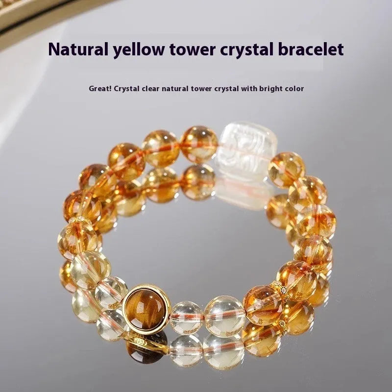 Close-up of a women's carved citrine bracelet with geometric patterns on 10mm crystal beads.