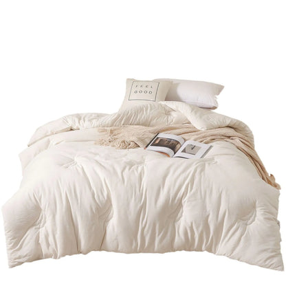 A pure cotton soybean fibre quilt in grey, showing its twill weave texture, laid flat on a bed.