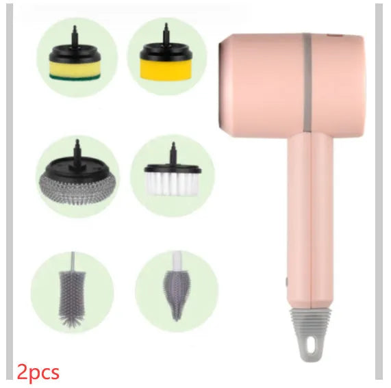 Green electric cleaning brush with scouring pad and brush heads on a kitchen worktop.