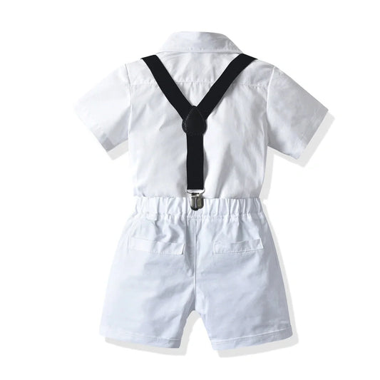 Boys' white short-sleeved shirt with suspender shorts set showing single-breasted closure and adjustable straps