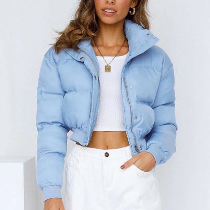 Women's loose-fit long sleeve polyester jacket in blue on a hanger.