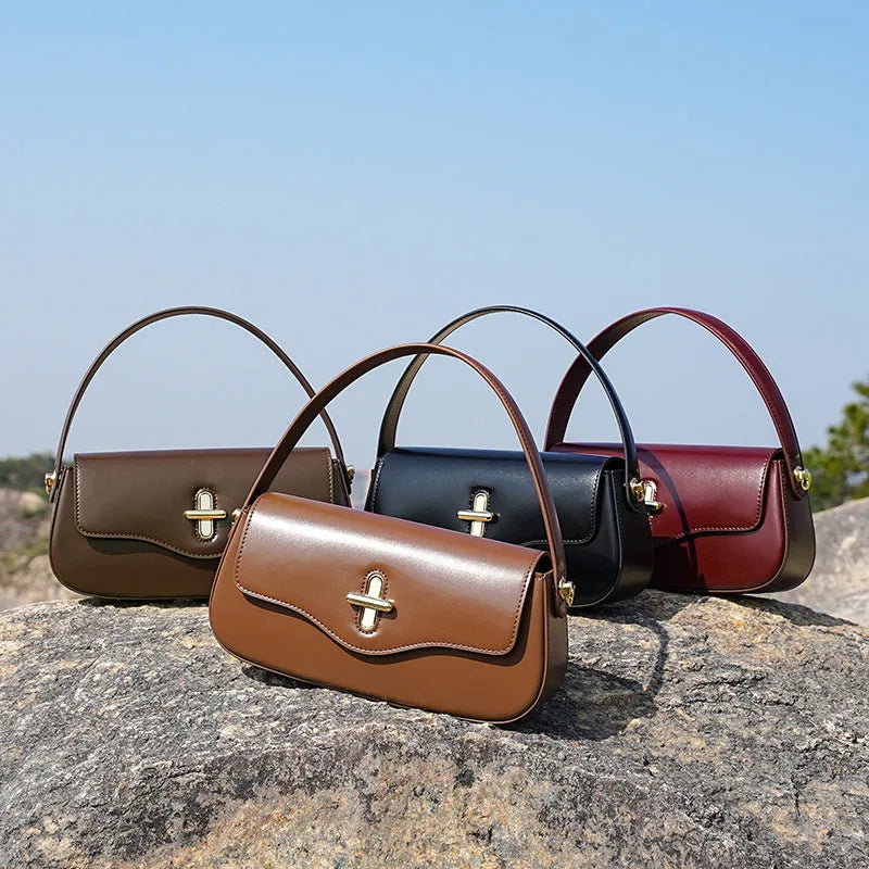 Genuine leather baguette handbag in clamshell design with internal organiser compartments