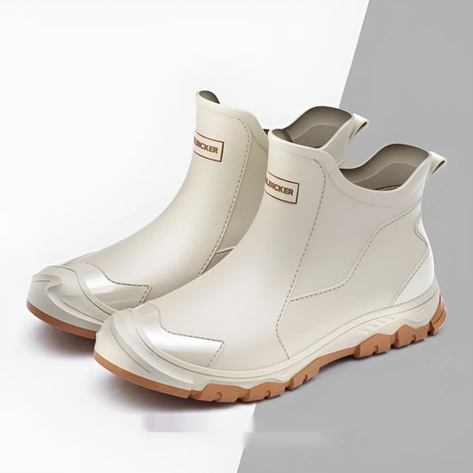 Low-cut solid colour PVC rain boot with round toe and plastic sole.