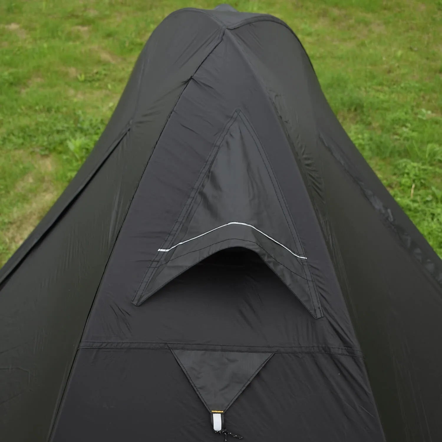 Single person tent with aluminium poles, silicon coating, and double-layer design in black colour, set up outdoors