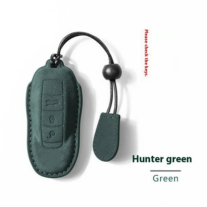 Suede car key cover in cement grey, dark green, light grey, and orange colour options