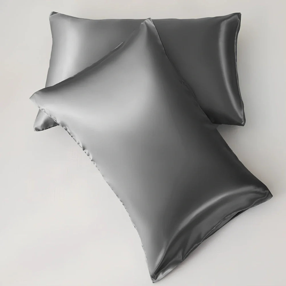 Silk-effect satin envelope pillowcase in navy blue showing envelope closure and smooth fabric texture