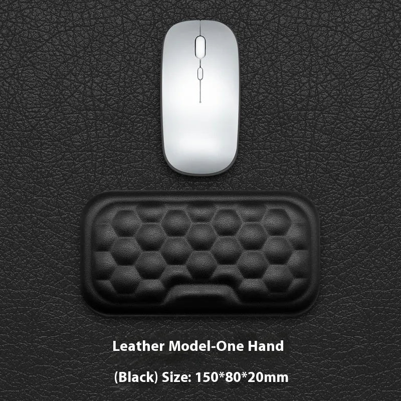 Black and grey memory foam mouse wrist rests with cloth and leather-style covers on a desk.