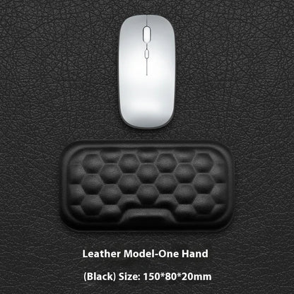 Black and grey memory foam mouse wrist rests with cloth and leather-style covers on a desk.
