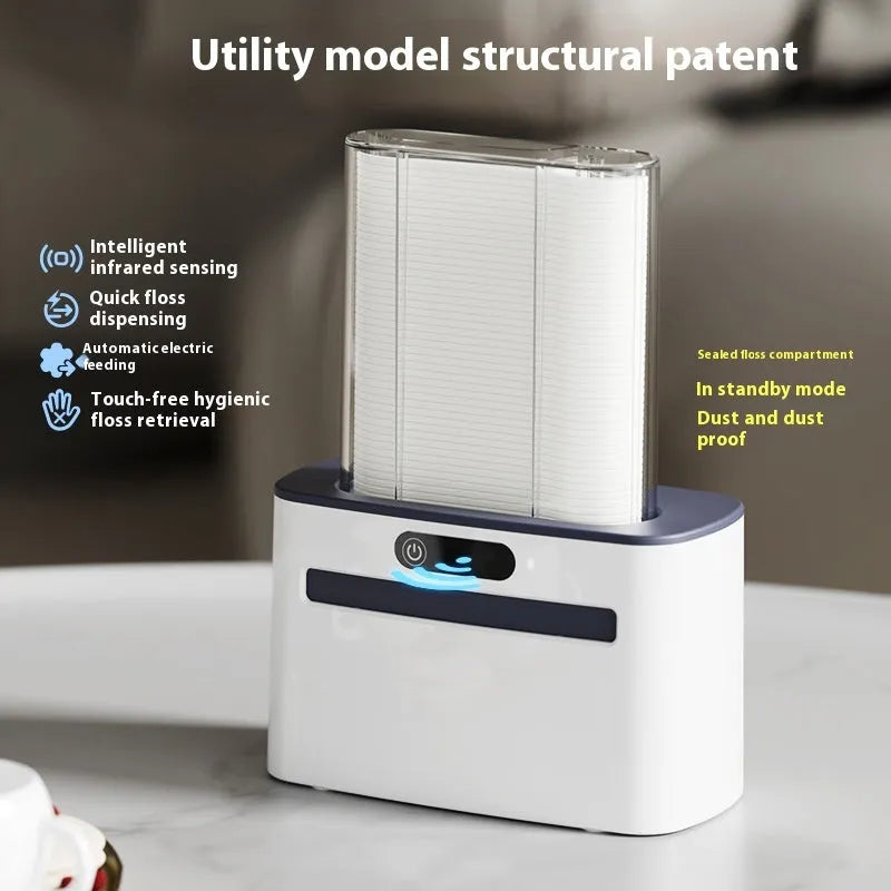 Dark grey automatic electric dental floss box with pop-up mechanism on a bathroom counter.