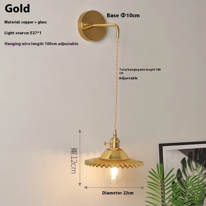 Retro brass lotus wall lamp with copper body and glass shade in various colours, mounted on a wall
