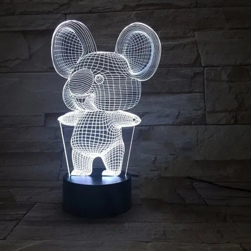 Black Koala night light with LED illumination on a bedside table.