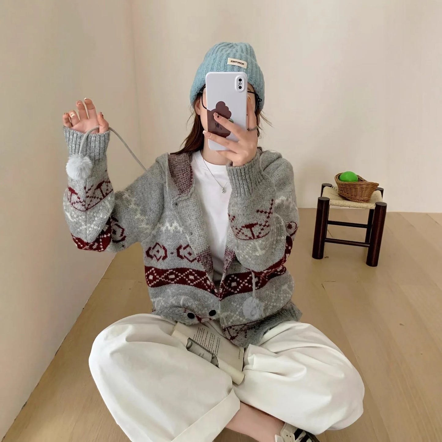 Women's loose-fit brocade sweater coat with geometric pattern in milky white colour, showing long sleeves and regular sleeve cut