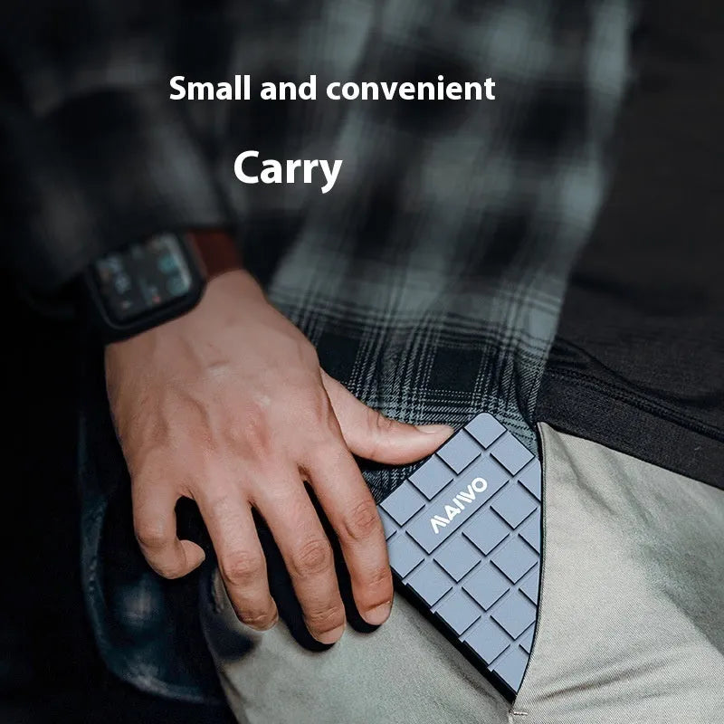 Silver aluminium alloy USB4 hard disk enclosure for M.2 SSDs, shown next to a laptop.