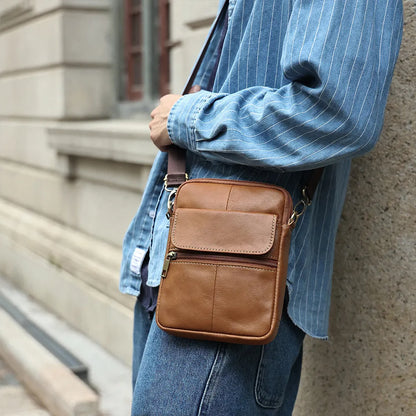 Men's brown leather crossbody shoulder bag with visible stitching and polyester cotton lining