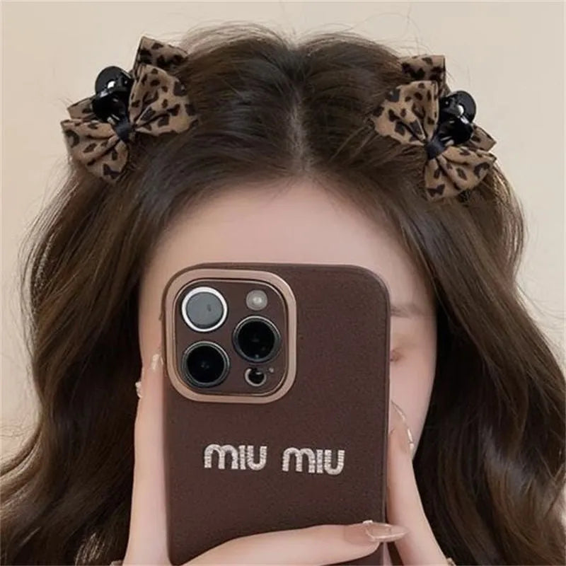 Pair of plastic hair barrettes with bow, leopard, bead and triangle styles for women's bangs