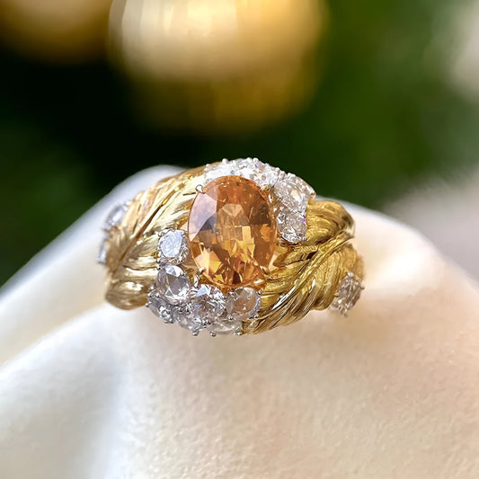 Gold colour copper ring with embossed feather pattern and inlaid yellow zircon, showing geometric shape and detailed texture