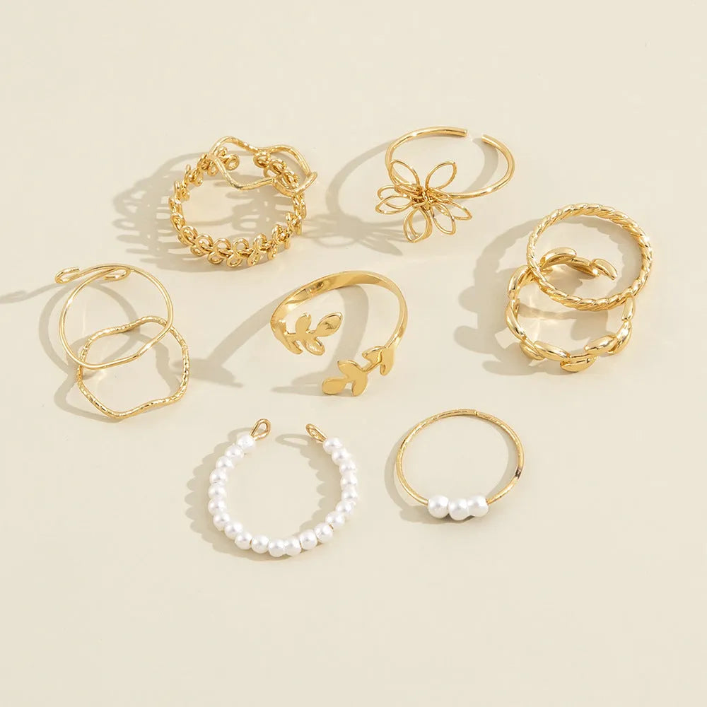 Women's gold openwork flower ring set showing detailed floral cut-out pattern and glossy electroplated finish