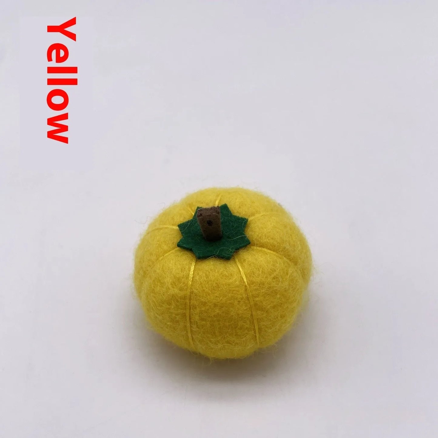 Wool felt pumpkin ornaments in various colours for doll decoration and craft projects.