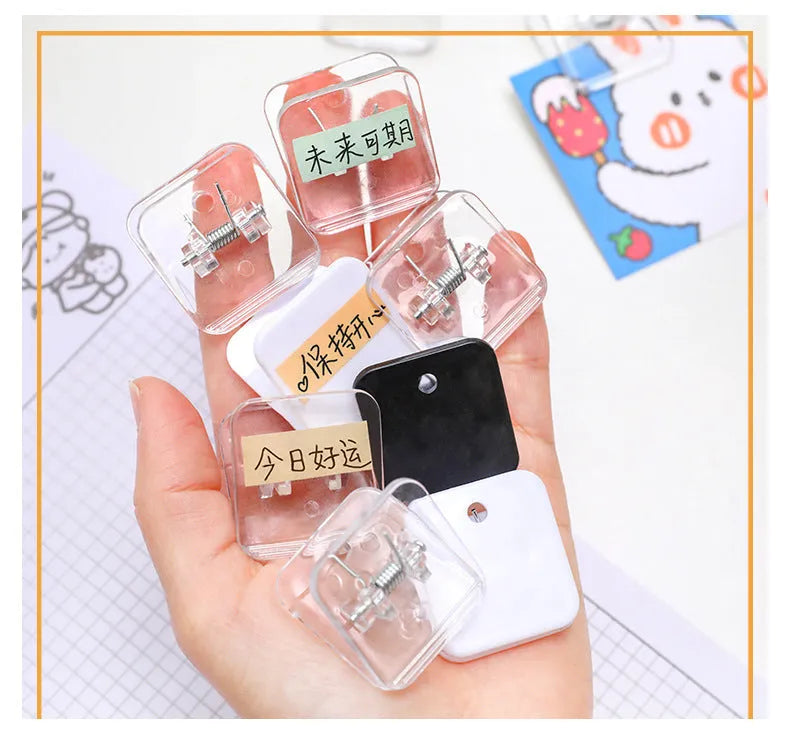 Square plastic photo holder in black, white, and transparent colour options on desk
