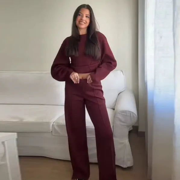 Women's black fleece tracksuit set featuring a pleated long sleeve top and wide leg trousers