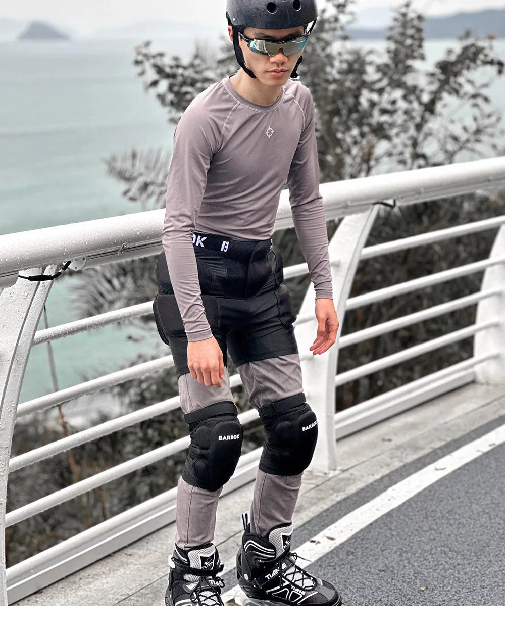 Black roller skating hip pad pants with NBR foam protection panels for skateboarding