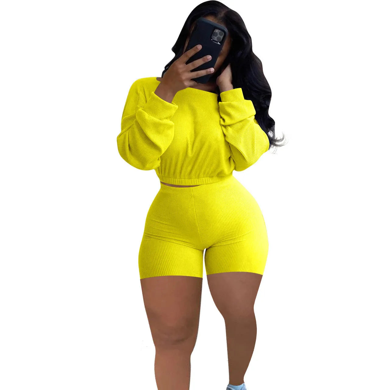 Women's long sleeve off-the-shoulder top and shorts two-piece set in a solid colour.