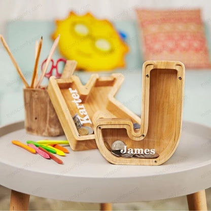 Wooden letter-shaped coin bank with clear glass panel to watch savings grow, a decorative and functional home accent.