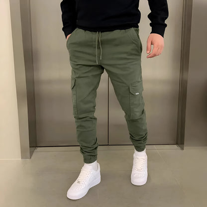 Men's loose-fit casual trousers with elastic waistband and patch pockets in army green colour