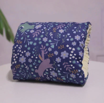 Adjustable cotton nursing pillow with various colorful designs, providing comfort and support for breastfeeding and bottle-feeding