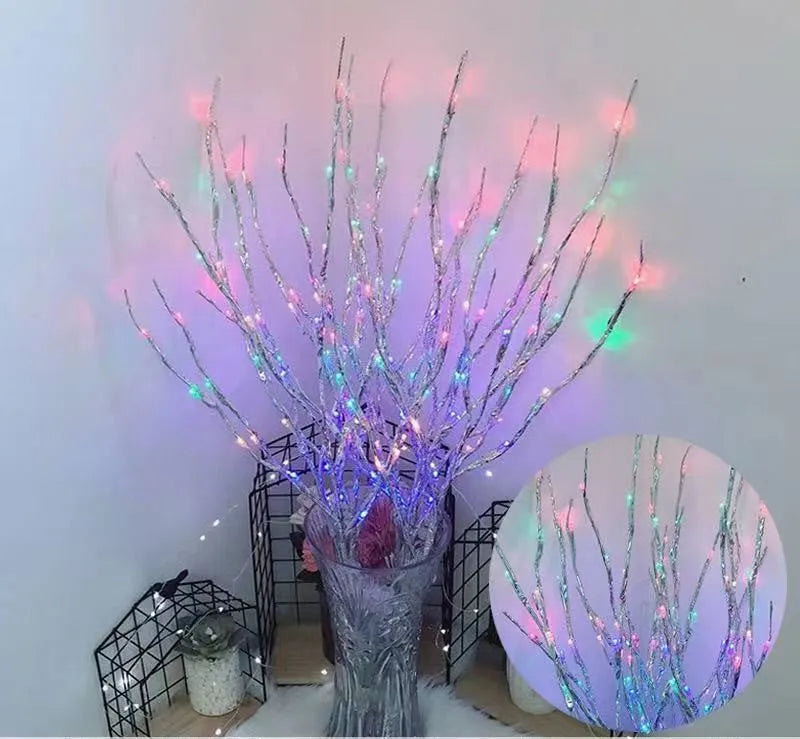 Silver branch LED tree light in a vase with multiple colour change modes including blue, pink, and warm white.