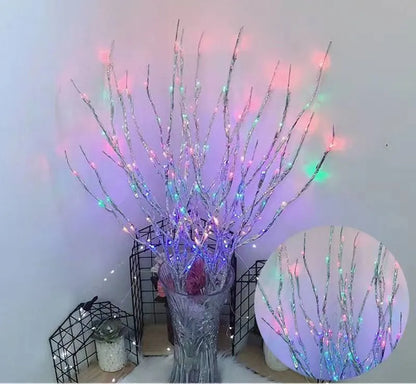Silver branch LED tree light in a vase with multiple colour change modes including blue, pink, and warm white.