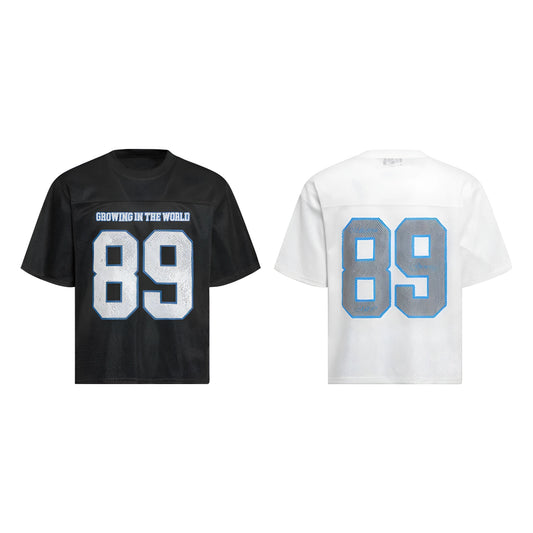 Man modelling a black loose-fitting T-shirt with a white alphanumeric graphic print on the chest.