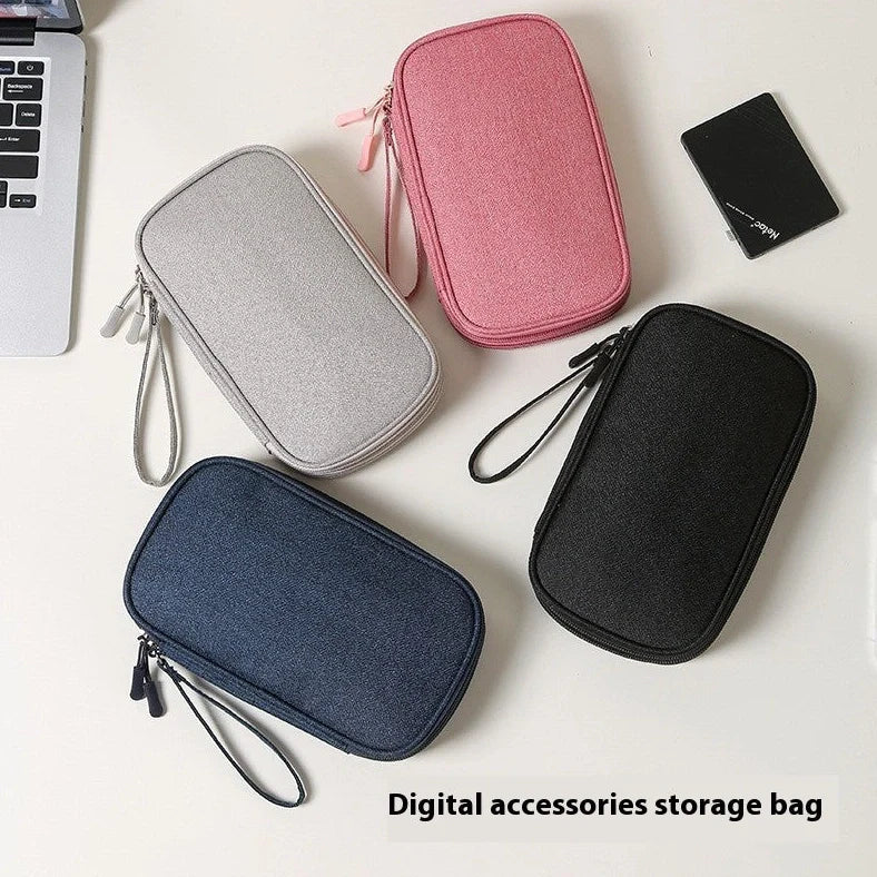 Light grey portable buggy bag for cable storage measuring 19x11x3cm with handbag-type shape