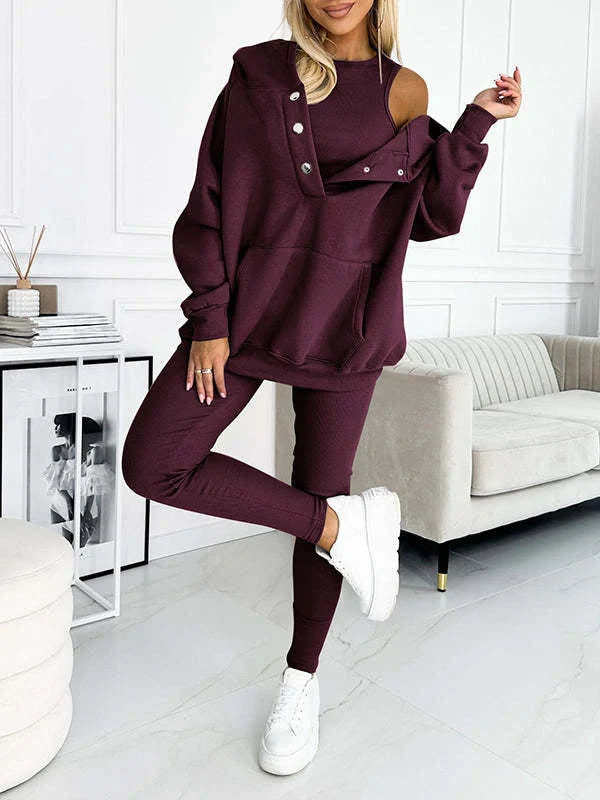 Women's 3-piece sports suit featuring a hooded sweatshirt with pockets and slim trousers