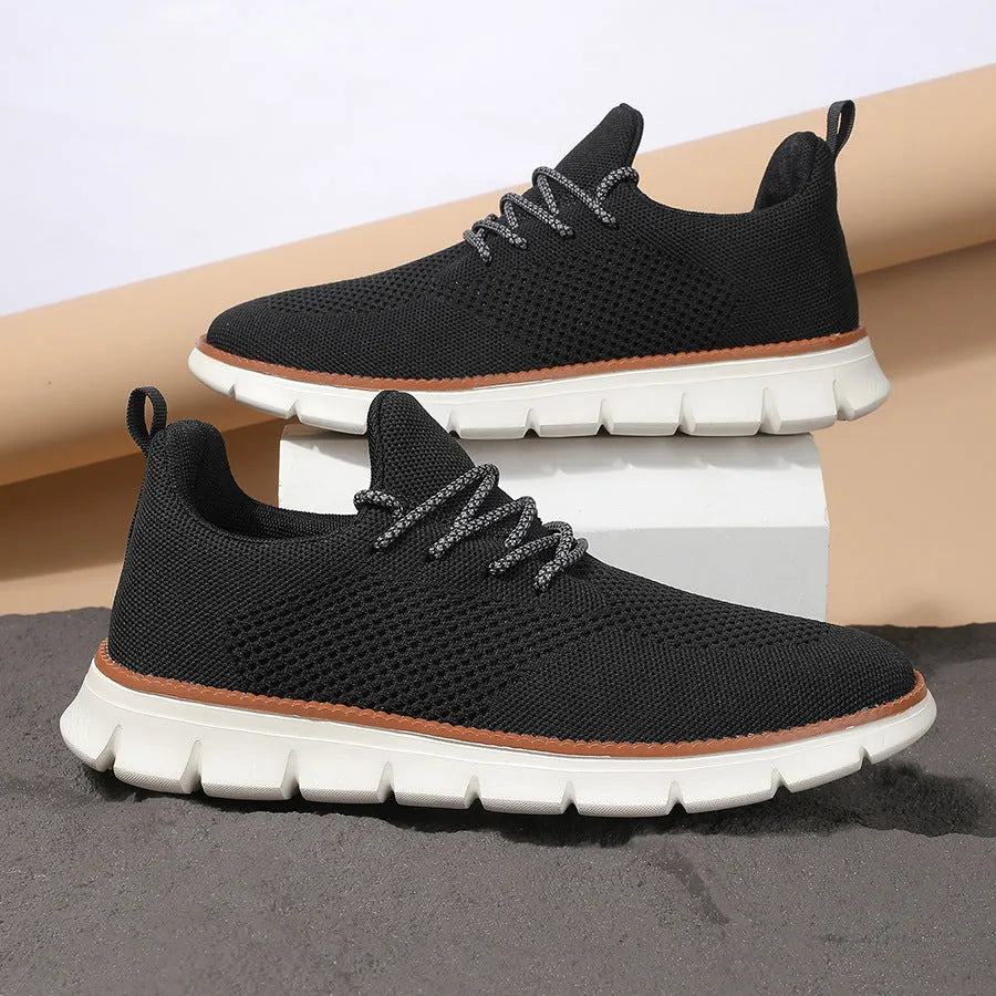 Men's grey and black low-top casual sneakers with a breathable mesh fabric upper.