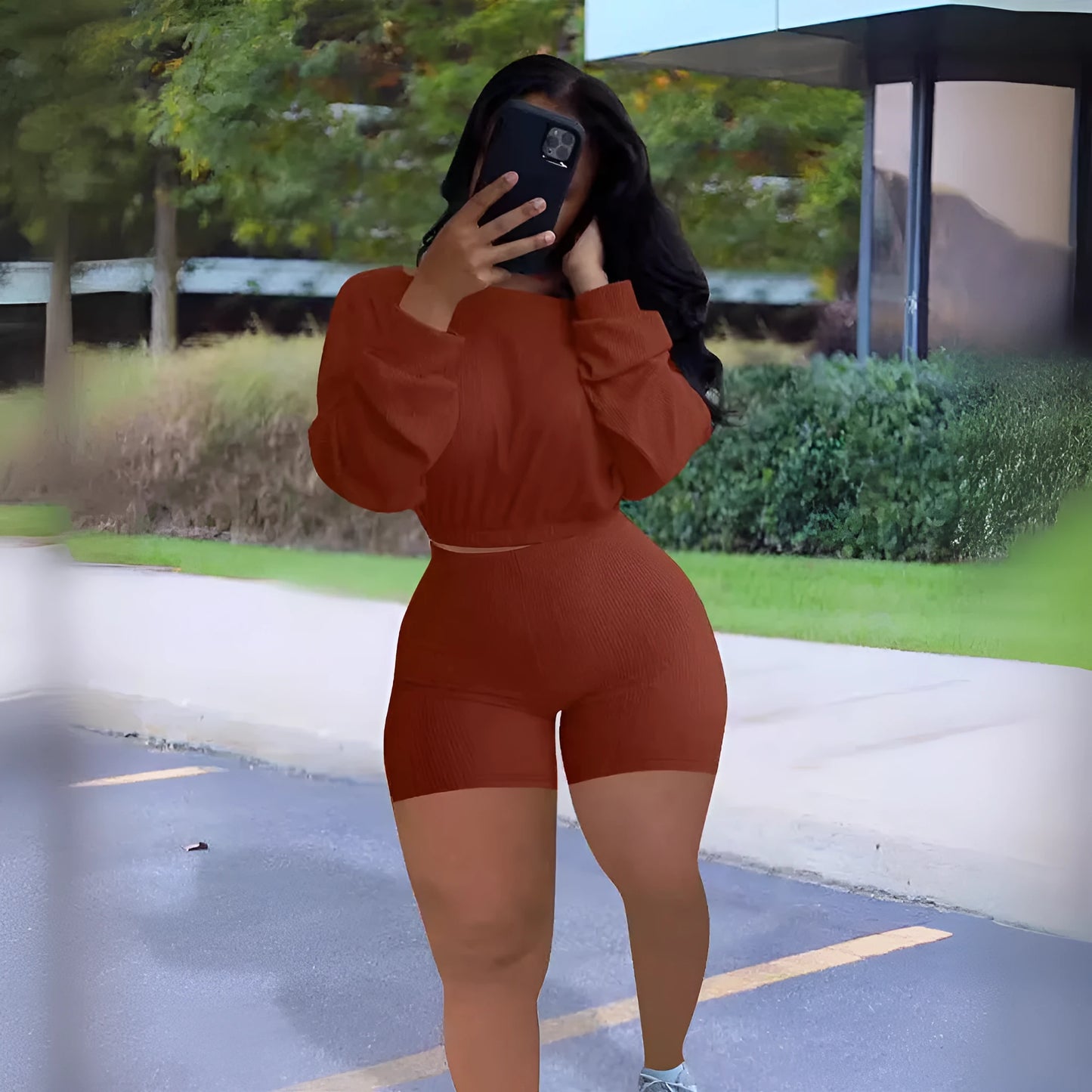 Women's long sleeve off-the-shoulder top and shorts two-piece set in a solid colour.