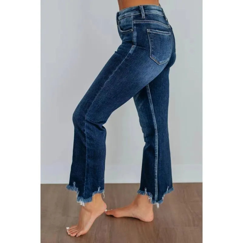 Women's solid colour denim trousers with hand-worn finish in dark blue, showing casual styling and 100% cotton construction