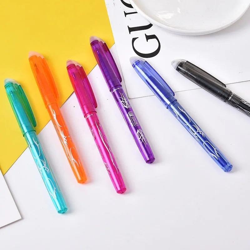 A set of hot erasable gel pens in multiple colours with plastic bodies and stainless steel nibs, shown with a hairdryer to illustrate the heat-erasable function.