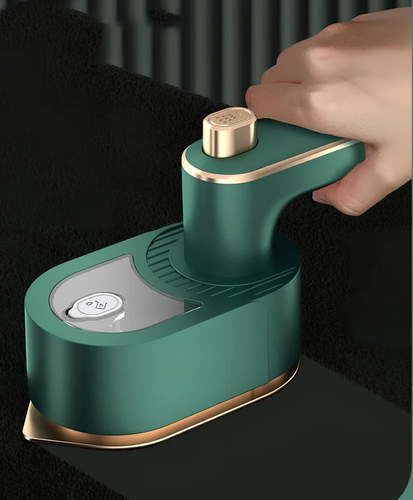 Green folding handheld garment steamer showing extended and collapsed positions with water tank visible