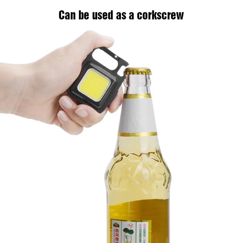 Black aluminium alloy USB rechargeable keychain light with magnetic base and foldable handle