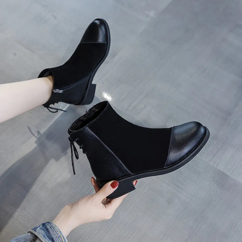Women's black knee-length Martin boots with side zipper, non-slip rubber sole, and bow detail on microfiber upper