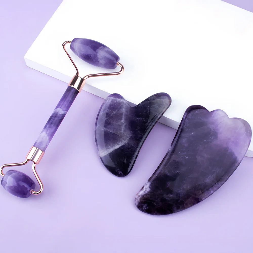 Amethyst facial roller set with heart-shaped gua sha and claw massage tools on white background