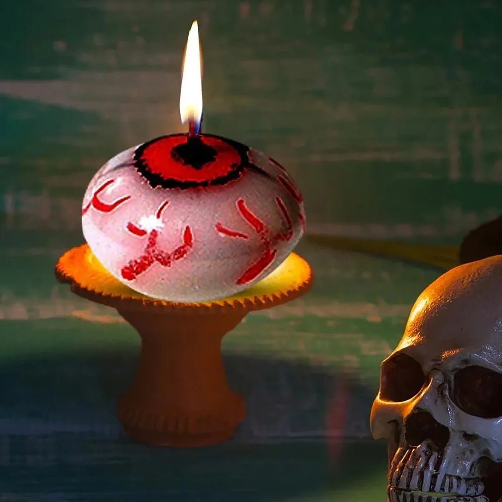 Red oval paraffin floating candle resembling eyeball in Halloween water display