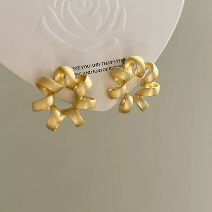 Trendy gold circle twists stud earrings for women, perfect for daily wear and parties.