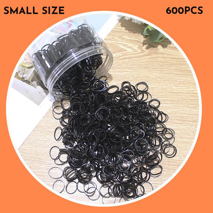 Multicoloured assortment of thin TPU elastic hair bands for babies and children in a reusable plastic container.