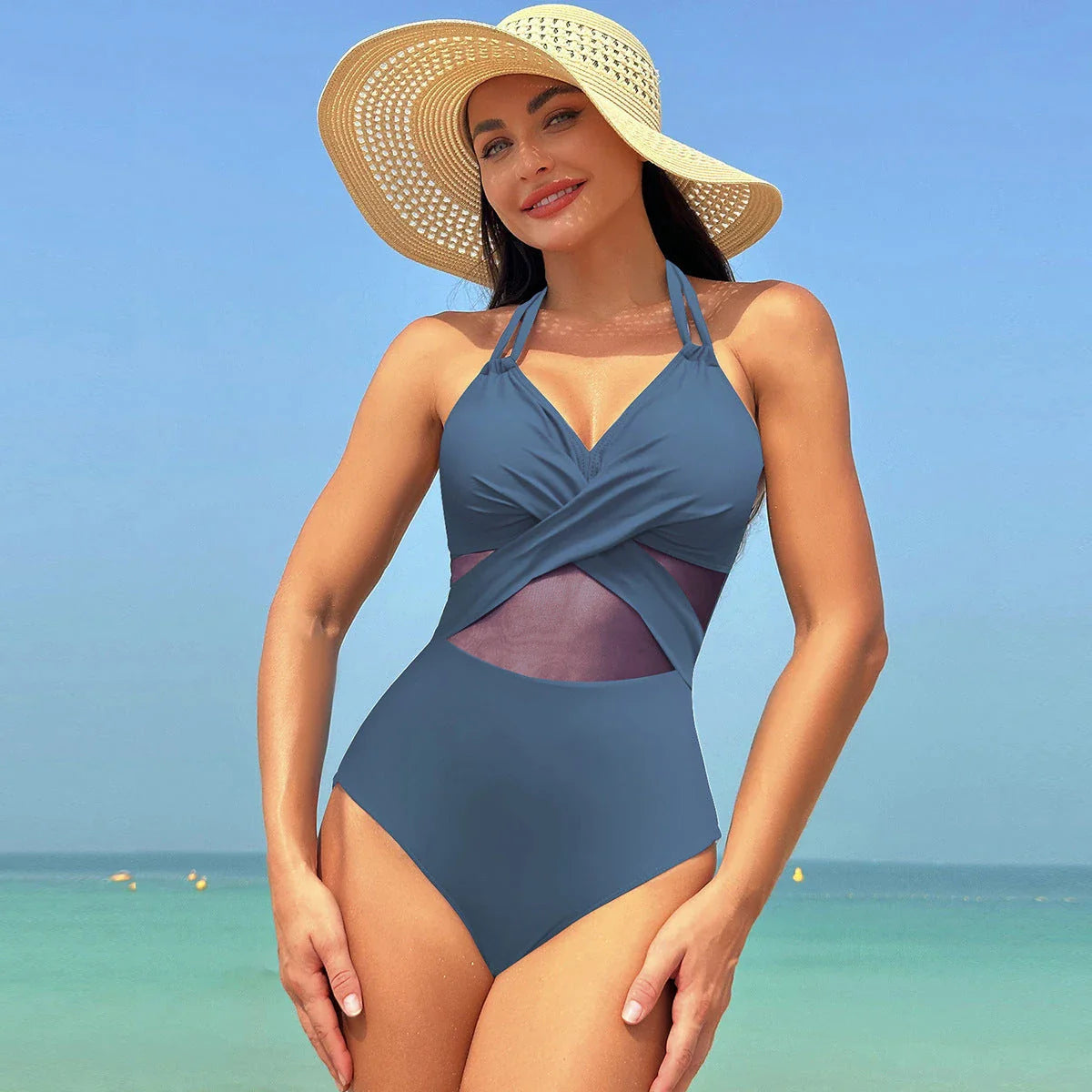 Halter one-piece swimsuit with cross-strap design, available in various solid colors and leopard print