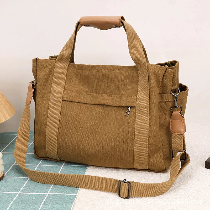Army Green canvas tote bag showing open top with internal laptop pocket and organisers.