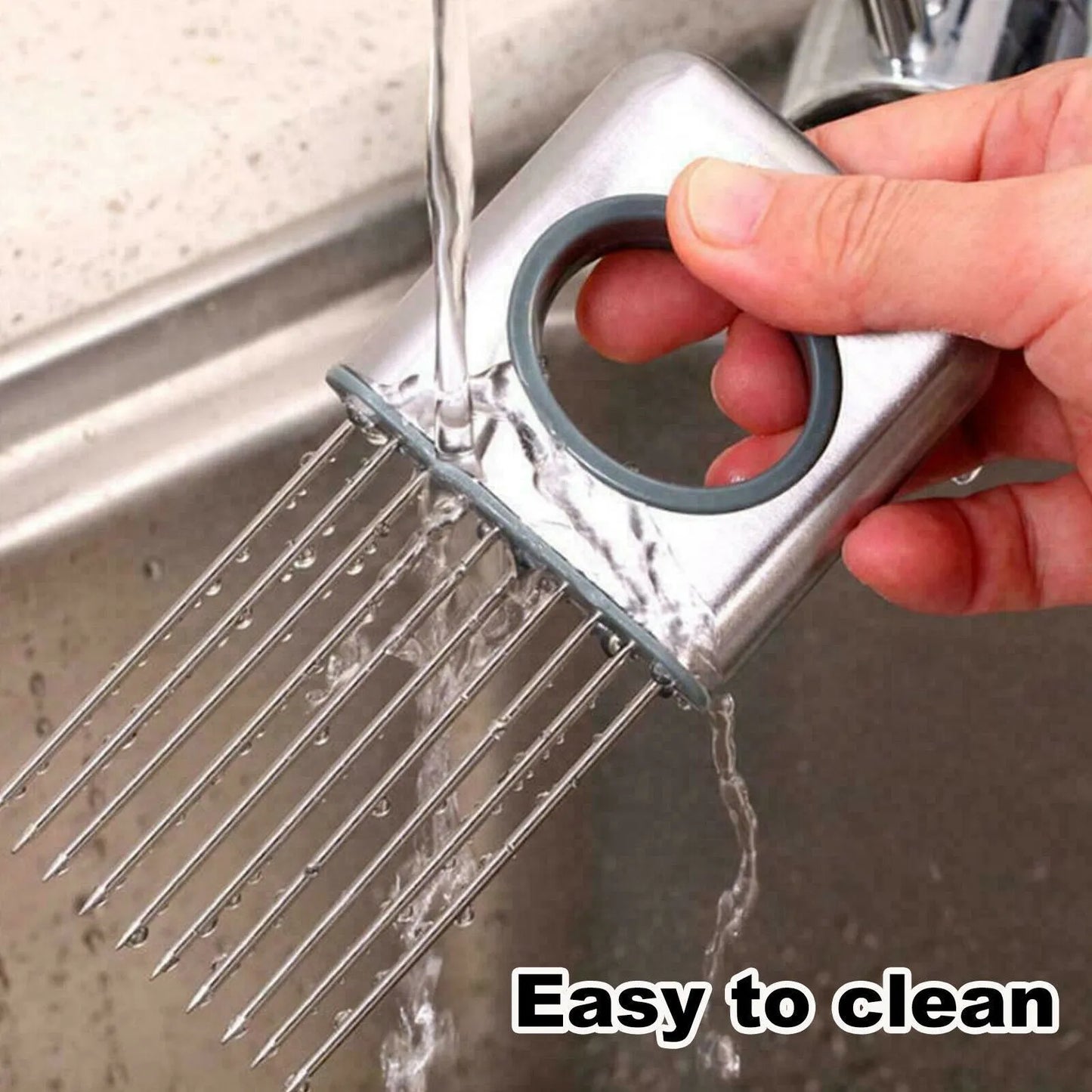 Stainless steel onion holder slicer tool with sharp prongs and a finger guard protector on a kitchen surface.