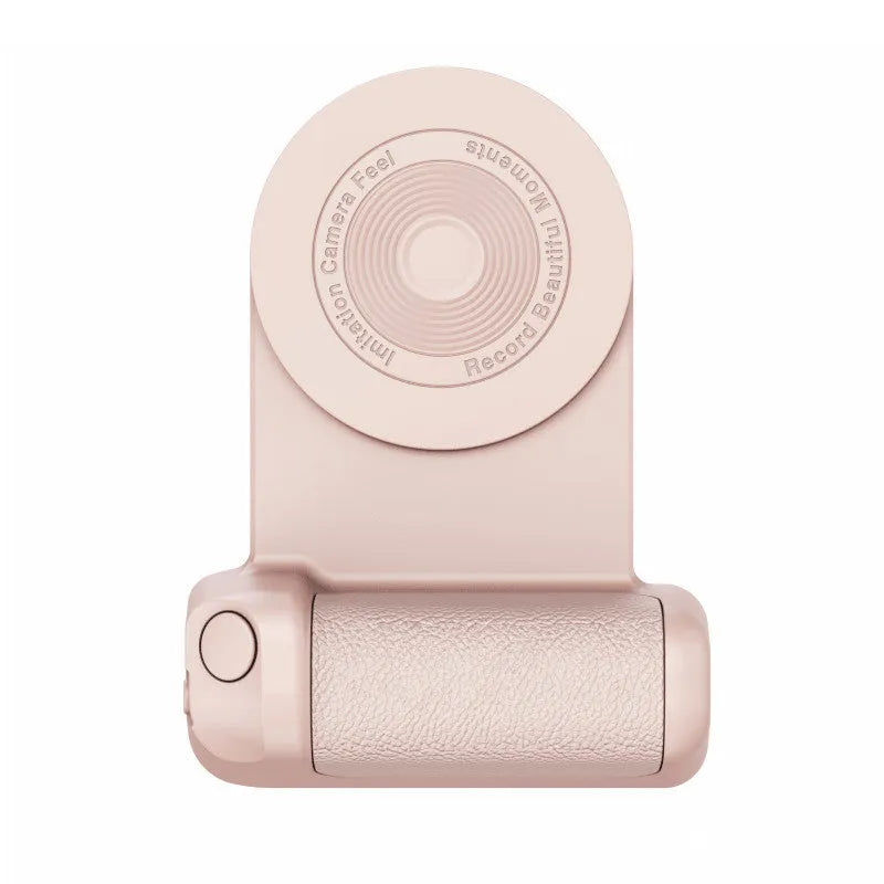 Black magnetic phone camera grip holder with rotatable stand on a table next to a smartphone.