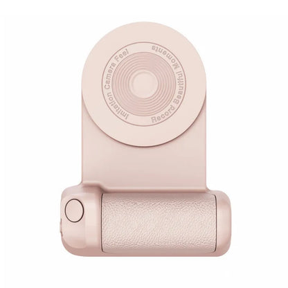 Black magnetic phone camera grip holder with rotatable stand on a table next to a smartphone.